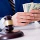 Lawyer distributes money awarded in a personal injury settlement in Florida