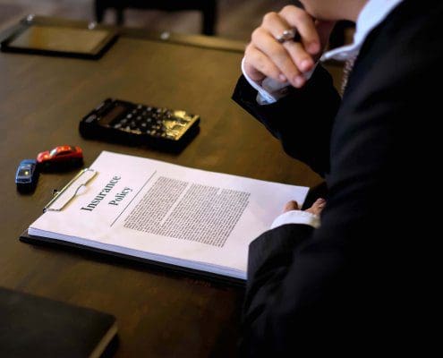 Lawyer discusses denial of auto insurance claim with client in Florida