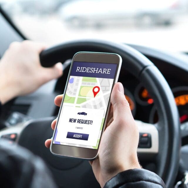 a person holding a phone while driving